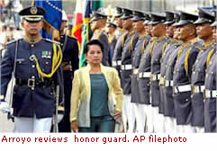 Arroyo reviews  honor guard. AP filephoto