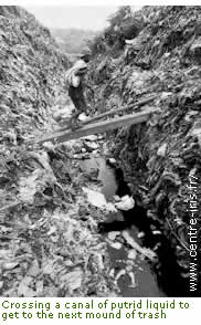 Crossing canal of putrid liquid at Payatas garbage dump