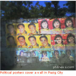 Political posters cover a wall in Pasig City