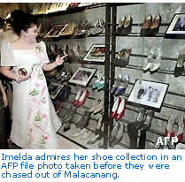 Imelda admires her shoe collection in an AFP file photo taken before they were chased out of Malacanang. 