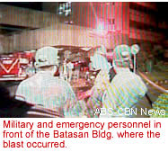 Military and emergency personnel in front of the Batasan Bldg. where the blast occurred. 