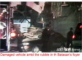 Damaged vehicle amid the rubble in th Batasan's foyer