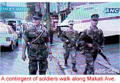 A contingent of soldiers walk along Makati Ave.