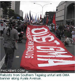 Rallyists from Southern Tagalog unfurl anti GMA banner along Ayala Avenue.