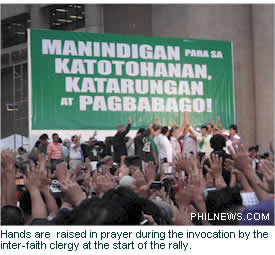 Hands are  raised in prayer during the invocation by the inter-faith clergy at the start of the rally.