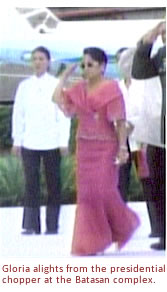 Gloria alights from the presidential chopper at the Batasan complex.