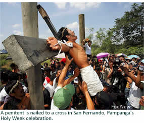 A penitent is nailed to a cross in San Fernando, Pampanga's Holy Week celebration