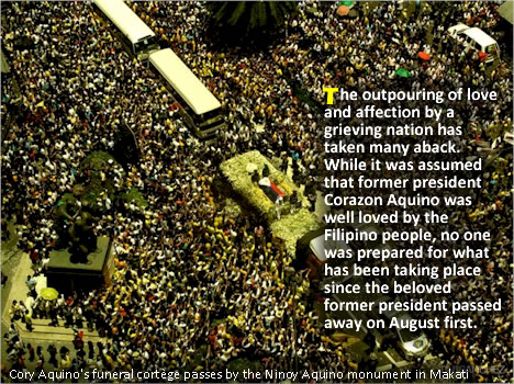 Cory Aquino's funeral cortge passes by the Ninoy Aquino monument in Makati