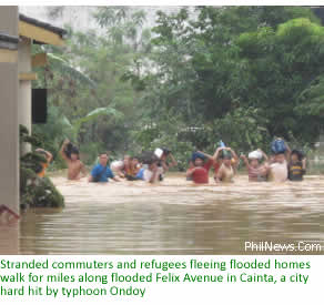 Stranded commuters and refugees fleeing flooded homes walk for miles along flooded Felix Avenue in Cainta, a city hard hit by typhoon Ondoy