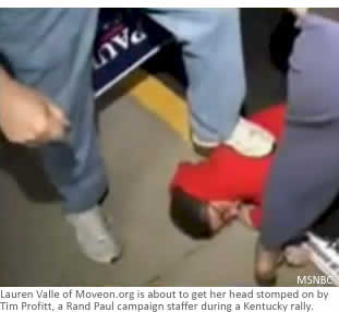 Lauren Valle of Moveon.org is about to get her head stomped on by Tim Profitt, a Rand Paul campaign staffer during a Kentucky rally