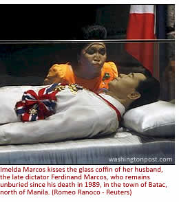 Imelda Marcos kisses the glass coffin of her husband, the late dictator Ferdinand Marcos