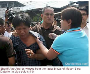 Sheriff Abe Andres winces from the facial blows of Mayor Sara Duterte (in blue polo shirt)