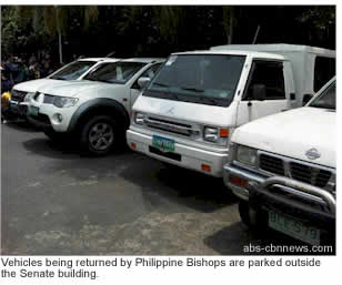 Vehicles being returned by Philippine Bishops are parked outside