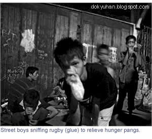 Street boys sniffing rugby (glue) to relieve hunger pangs