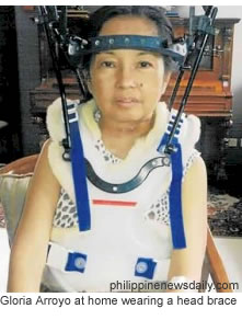 Gloria Arroyo at home wearing a head brace