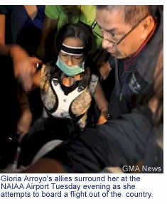 Gloria Arroyo's allies surround her at the NAIAA Airport Tuesday evening as she attempts to board a flight out of the  country