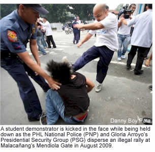 A student demonstrator is kicked in the face while being held down as the PHL National Police (PNP) and Gloria Arroyo's Presidential Security Group (PSG) disperse an illegal rally at Malacaang's Mendiola Gate in August 2009