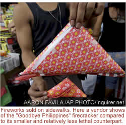 Fireworks sold on sidewalks. Here a vendor shows of the "Goodbye Philippines" firecracker compared to its smaller and relatively less lethal counterpart