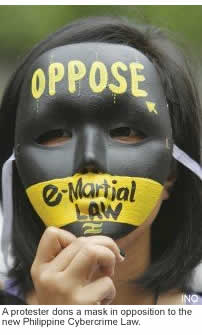 A protester dons a mask in opposition to the new Philippine Cybercrime Law