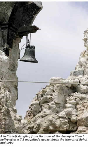A bell is left dangling from the ruins of the Baclayon Church belfry after a 7.2 magnitude quake struck the islands of Bohol and Cebu
