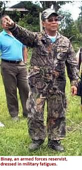 Binay, an armed forces reservist, dressed in combat fatigues