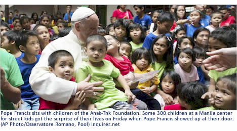 Pope Francis sits with children of the Anak-Tnk Foundation