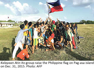 Kalayaan Atin Ito group raise the Philippine flag on Pag-asa island on Dec. 31, 2015