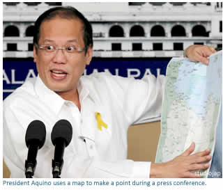 President Aquino uses a map to make a point during a press conference