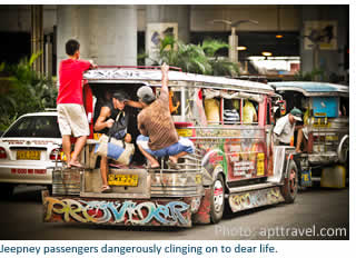 Jeepney passengers dangerously cling on to dear life.